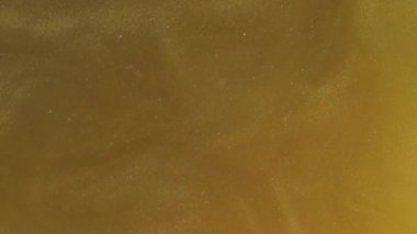 Turuncu ışıltı. Parıltılı boya. Köpüklü, bol köpüklü su karışımı. Sisli bukleleri ve soyut arkaplanı olan mistik, sarı, altın bir arka plan..