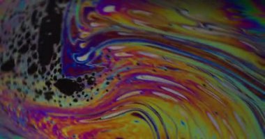 Damlacık yağı. Renk karışımı. Odaklanamayan sarı mor mavi mürekkep su dokusu akan yeşil yuvarlak lekeler soyut sanat arka planına dökülüyor.