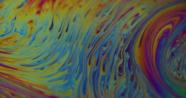 Yakıt dökülüyor. Yanardöner sanat. Bulanık sarı mavi mor renk akan kimyasal boya suyu soyut yaratıcı arka planda yüzer..