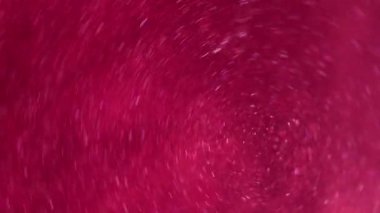 Sanat girdabı. Boya girdabı. Odaklanamayan pembe parlak sıvı spiral akışı. Sihirli yuvarlak sualtı karışımı soyut arkaplan.