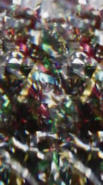 Dikey video. Konfeti dokusu örtüşüyor. Bulanık tatil kıvılcımları. Bokeh ışık soyut arkaplanda daireler çizen renkli kırmızı parlak parçacıklar..