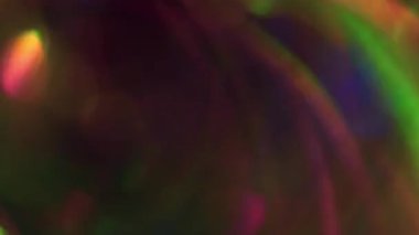 Işık akışı. Odaklanamayan çok renkli doku. Parlak yeşil turuncu mavi mercek Bokeh soyut koyu modern arka planda kıvrılıyor..