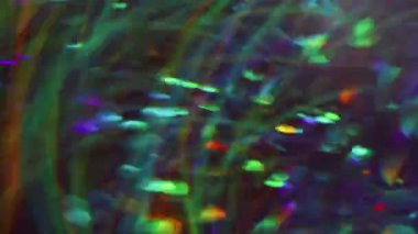 Neşeli bir parıltı. Bulanık sızıntı rengi. Yeşil turuncu mavi yanıp sönen mercek modern Bokeh Işığı 'nın soyut arka planında yanıp sönüyor.