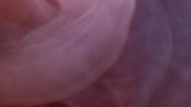 Dikey video. Sanat dumanı. Dalga sisi. Fantezi suluboya mürekkep karışımı bulanık sıvı parıldayan yuvarlak şekilli turuncu bakır soyut arka plan.