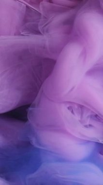 Dikey video. Sihirli buhar. Parlak boya. Odaklanmamış mor renkli sisli mürekkep dumanı soyut ışıldayan sanat arka planında parıldıyor.