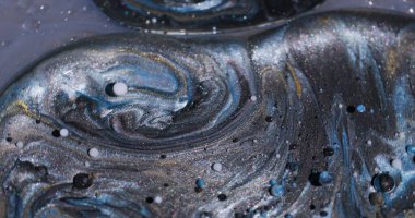 Renk akışı. Boya sıvısı. Odaksız mavi, altın sarısı, ışıl ışıl beyaz partiküller. Petrol kabarcıkları soyut yaratıcı arka planda akıyor..