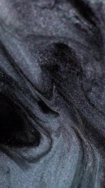 Dikey video. Işıldayan emülsiyon. Boya damlası. Karmaşık mürekkep jeli akryl metal toz sıvısı pürüzsüz gizemli soyut siyah gri gri bulanık arka plan dökülüyor.