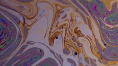 Pigment emülsiyonu. Boya lekeleri. Odaklanmamış turuncu mavi renk ıslak baloncuk yağlı doku soyut pembe arka planda yüzüyor.