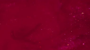 Parıltı dalgası. Girdabı boya. Canlı parçacıklar mürekkep emülsiyonu yayar. Kırmızı pembe renk dokusu soyut bulanık scintilla girdap arkaplanı.