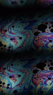 Dikey video. Girdap sabunu. Prizma etkisi. Benzin sıvısı renkli karışım flaş, soyut arkaplan çözünürlüğü. Yüzen boya kaleydoskobu.