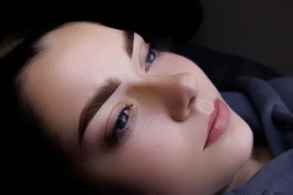 Permanent makeup of eyebrows, gorgeous girl model with permanent makeup of eyebrows after the procedure