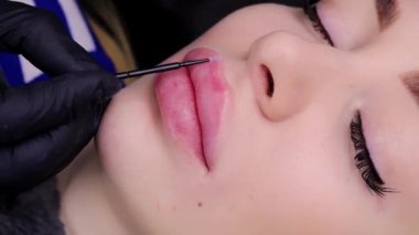 Kalıcı dudak makyajı işleminden önce model kızların dudaklarında anastasi uygulaması. Yüksek kalite 4k görüntü