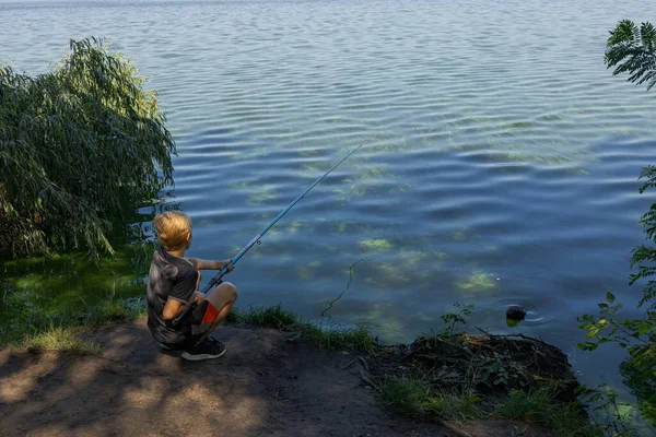 Στην Όχθη Ενός Ποταμού Ένα Αγόρι Ψαρεύει Βλέποντας Ένα Άρμα — Φωτογραφία Αρχείου