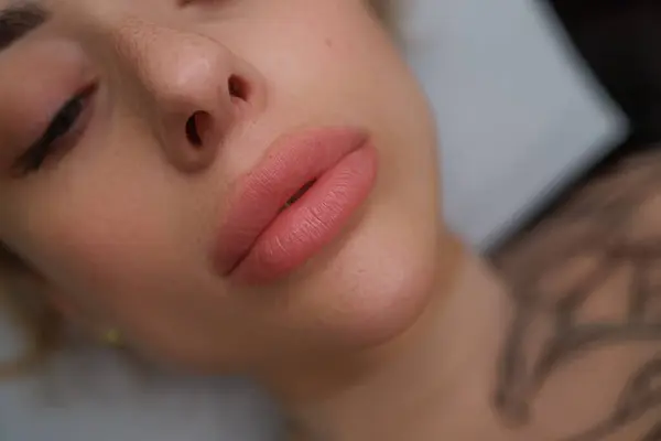 Lips of a young girl before a permanent make-up procedure. Delicate permanent lip makeup for blondes