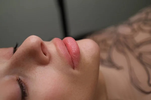 Lips of a young girl before a permanent make-up procedure. Delicate permanent lip makeup for blondes