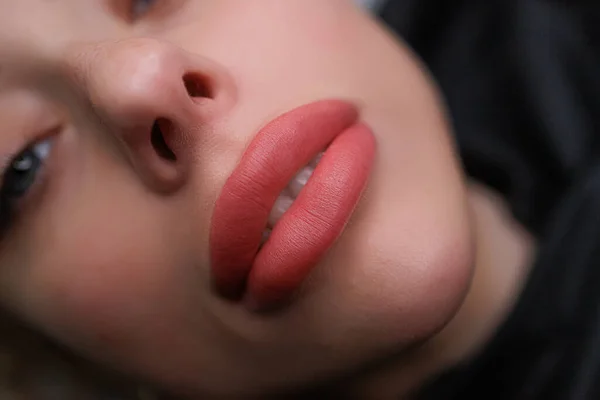 Beautiful and tender lips after the permanent make-up procedure. Delicate permanent lip makeup for blondes