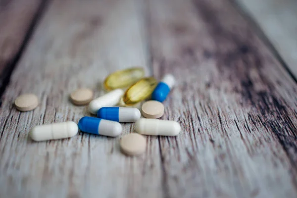 Scattered tablets over the surface nutritional supplements and vitamins.