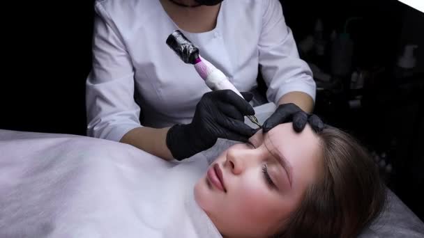 Fundo Escuro Mestre Uniforme Branco Realiza Procedimento Permanente Maquiagem Sobrancelha — Vídeo de Stock