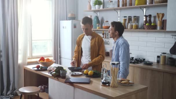 Happy Young Gay Couple Making Breakfast Together Talking Work Day — Stock Video