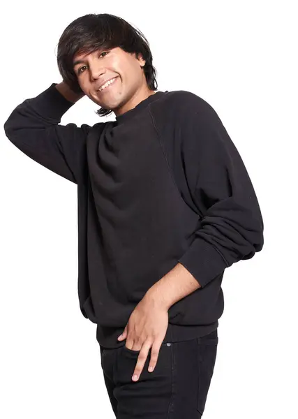 stock image 20 year old latin male model posing for the camera and smiling. He is dressed in black with white background. He is wearing black jeans.
