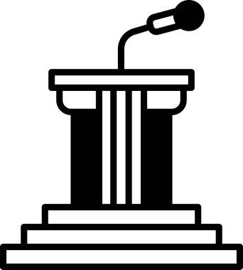 Podyumun üstünde bir mikrofon var. Mikrofon siyah ve gümüşten.