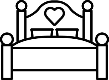 Üzerinde kalp olan bir çizgi film yatağı. Yatak kahverengi ve sarı.