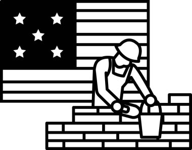 Bir adam Amerikan bayrağının önünde duvara tuğla örüyor. Bayrak siyah beyaz ve yıldızlı. Adam sıkı bir şapka takıyor ve bir inşaat alanında çalışıyor.
