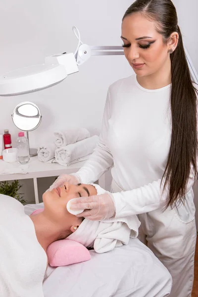 esthetician performing facial cleansing, skin care concept, . High quality photo