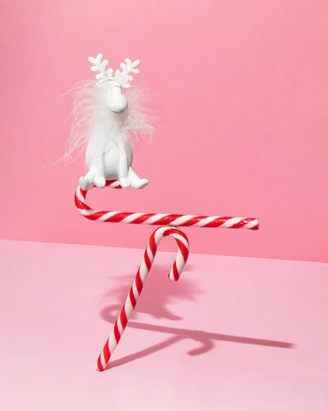 Candy Canes Reindeer Balancing Pastel Light Pink Background Minimalistic Xmas — Stock Photo, Image