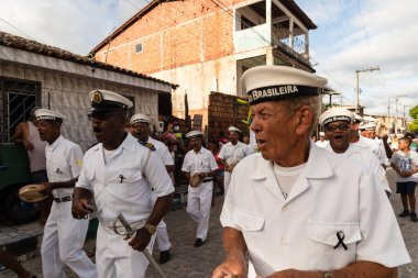 Saubara, Bahia, Brezilya - 06 Ağustos 2022: Encontro de Chegancas kültür grubu üyeleri beyaz kıyafetler giyer ve perküsyon enstrümanları çalarlar. Saubara, Bahia.