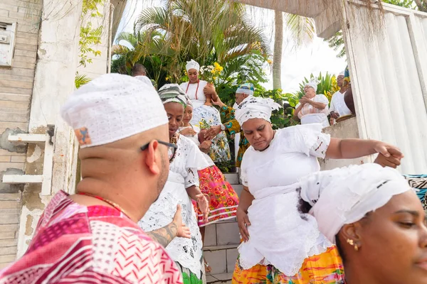 stock image Saubara, Bahia, Brazil - June 12, 2022: Candomble members descending a ladder dressed in traditional clothes for the religious festival in Bom Jesus dos Pobres district, Saubara city.