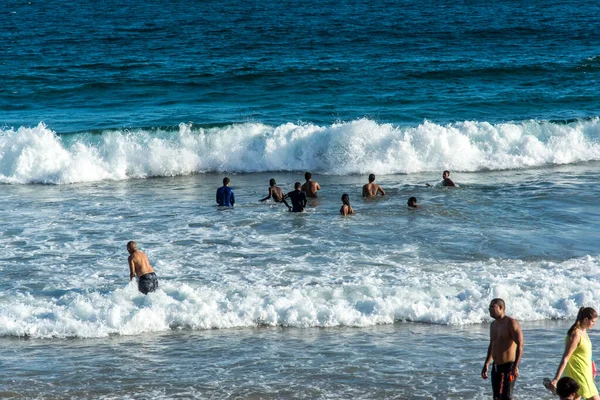 Stock image Salvador, Bahia, Brazil - October 22, 2022: People bathing in the sea at Farol da Barra beach in Salvador, Bahia.