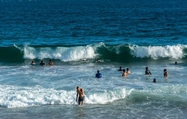 stock image Salvador, Bahia, Brazil - October 22, 2022: People bathing in the sea at Farol da Barra beach in Salvador, Bahia.