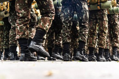 Salvador, Bahia, Brazil - September 07, 2022: Low view of the legs of Brazilian army soldiers marching through the streets of Salvador, Bahia, during the commemoration of independence. clipart