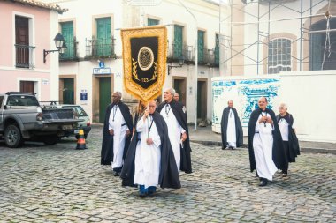 Salvador, Bahia, Brezilya - 26 Mayıs 2016: Katolik inananlar Bahia 'nın Salvador kentinde düzenlenen Corpus Christ günü töreninde Pelourinho sokaklarında pankartlarla yürüyorlar.