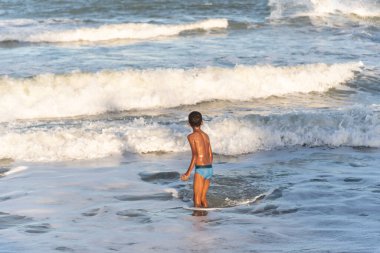 Sahildeki çocuk. Guaibim Plajı, Valenca, Brezilya.