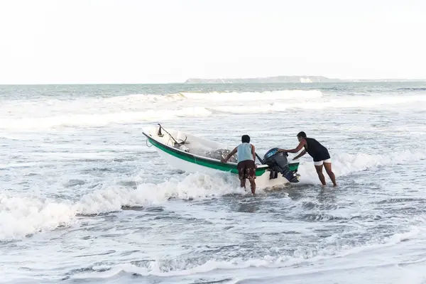 stock image Valenca, Bahia, Brazil - September 10, 2022: People entering the sea with a motorboat. Guaibim Beach, city of Valenca, Bahia.