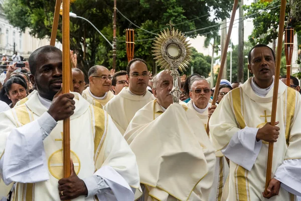 stock image Salvador, Bahia, Brazil - May 25, 2016: Priests and an archbishop are walking in the streets of Salvador, Bahia, during the Corpus Christ procession.