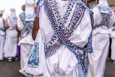 Salvador, Bahia, Brazil - February 11, 2018: Members of the traditional carnival block Filhos de Gandy are seen during the parade at the carnival in Salvador, Bahia.