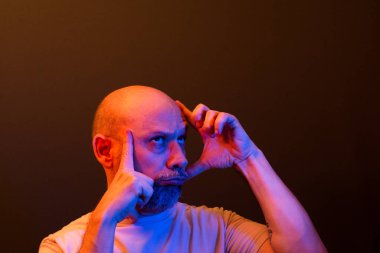 Orta yaşlı, komik, neşeli, el ve yüz hareketleri yapan bir adam. Eğlenceli konsept.