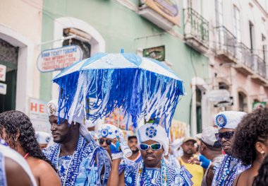Salvador, Bahia, Brazil - February 11, 2018: Members of the traditional carnival block Filhos de Gandy parade in the streets of Salvador, Bahia during the 2018 carnival.