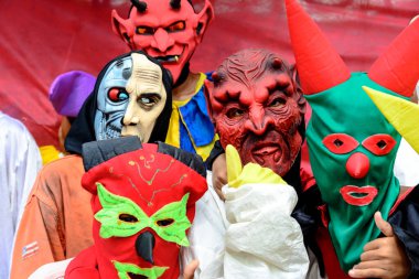 Maragogipe, Bahia, Brazil - February 27, 2017: Group of people dressed in horror costumes against red background at Maragojipe Carnival, Bahia.