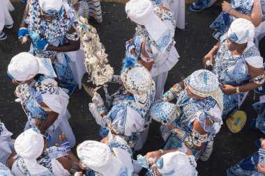 Salvador, Bahia, Brazil - February 11, 2018: Crowd of members of the traditional carnival group Filhos de Gandy, parade in the streets of Salvador, Bahia, during Carnival.