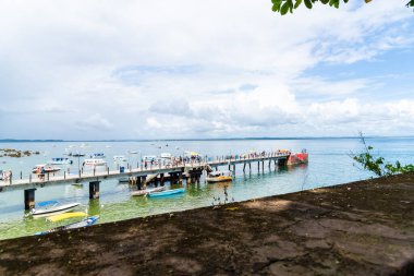Cairu, Bahia, Brazil - January 19, 2023: People walking on the maritime pier of Morro de Sao Paulo, in the city of Cairu.