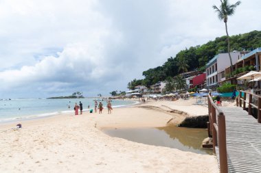 Cairu, Bahia, Brazil - January 19, 2023: People walking on the sands of Morro de Sao Paulo beach, in the city of Cairu.