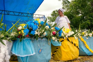 Candomble member guarding gifts for Iemanja's feast in the city of Cachoeira, Bahia.