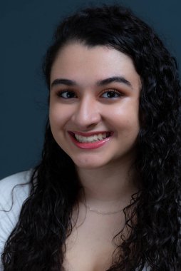 Close-up portrait of beautiful relaxed young woman. Isolated against dark background.