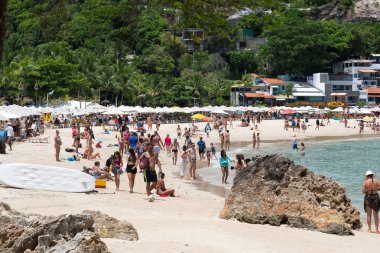 Cairu, Bahia, Brazil - January 19, 2023: People walking on the sands of Morro de Sao Paulo beach, in the city of Cairu.
