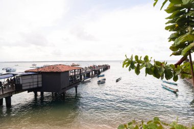Cairu, Bahia, Brazil - January 19, 2023: People walking on the maritime pier of Morro de Sao Paulo, in the city of Cairu.