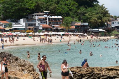 Cairu, Bahia, Brazil - January 19, 2023: People walking on the sands of Morro de Sao Paulo beach, in the city of Cairu.